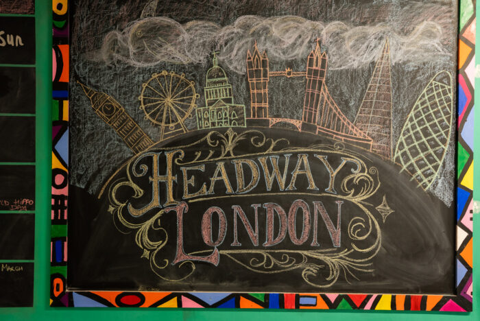 A photograph of a chalk board inside Headway East London's space